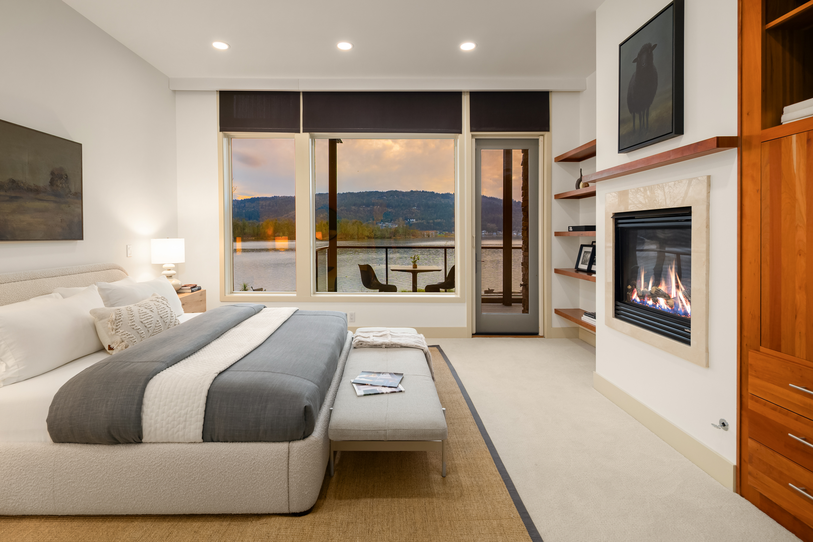 Primary suite with lake view and fireplace